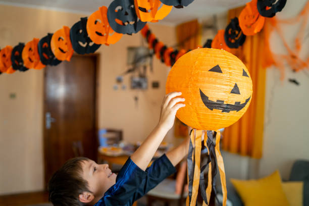 istock Small boy reaching for the jack o' lantern decoration 1658000162