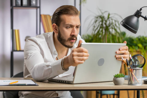 istock Irritated tired businessman working on laptop website problem, computer virus data loss by hacking 1658001817