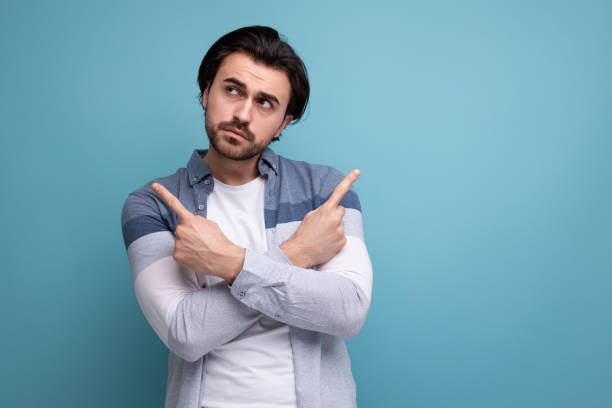 istock pensive brunette guy in a model appearance dreams on a studio background 1658007517