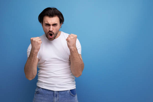 istock confident young brunette guy in a white t-shirt and jeans 1658007817