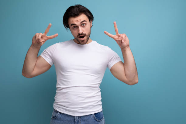 istock confident young brunette guy in a white t-shirt and jeans 1658007919