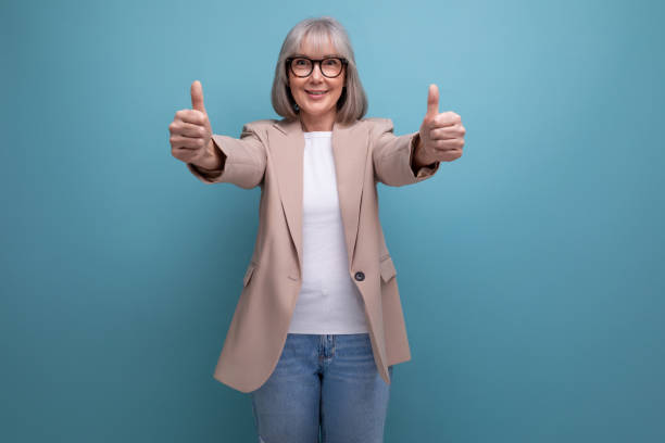 istock smiling middle-aged woman in a stylish jacket smiling on a bright studio background 1658011008