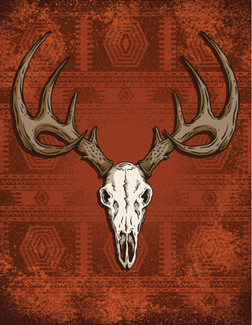 A beast of a deer skull rests on a grungy Southwestern style rug background.