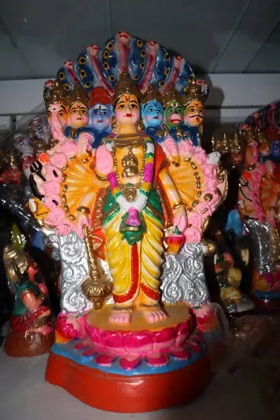 Photo of A Colorful Doll of Multi headed God depicting Shiva, Vishnu, Ganesh, Brahma, Hanuman, Krishna of Mythological characters worshipped during Diwali and Dasara festival in India.