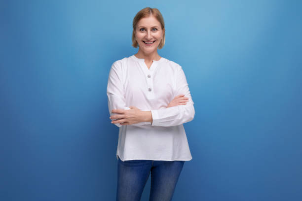 istock healthy slim blond mature woman smiling on studio background 1658047876