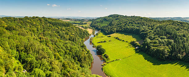 istock Idyllic country river meadering through green summer valley 165807516