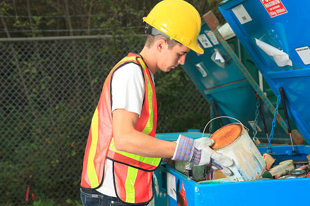 Recycling Worker - Paint Recycle Recycling Worker - Paint Recycle iron county wisconsin stock pictures, royalty-free photos & images