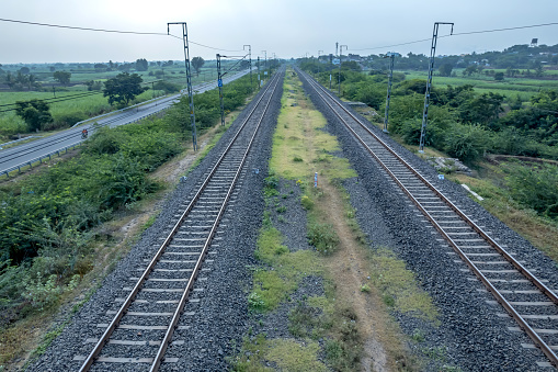 Twin railway tracks on the Daund Ahmednagar line alongwith the parallel  Daund to Ahmednagar road or State Highway 10 at Daund India.