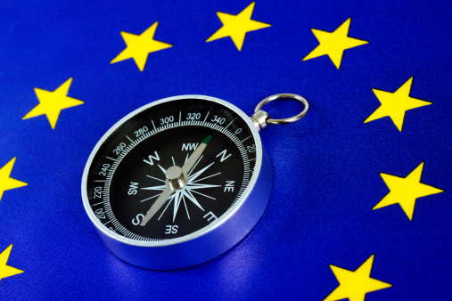 European Union Flag with Compass. Toned Image.