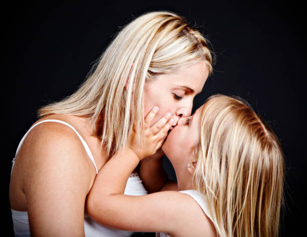 istock Mother and daughter kissing 165823877