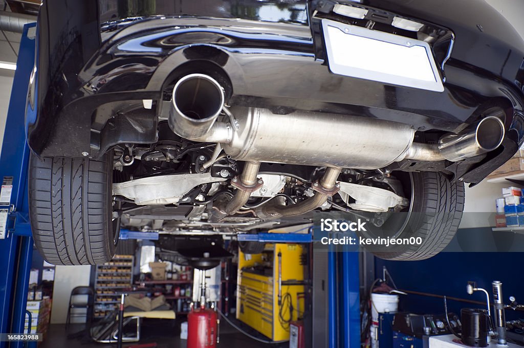 Auto Repair Cars up on lifts in an auto repair shop. Exhaust Pipe Stock Photo