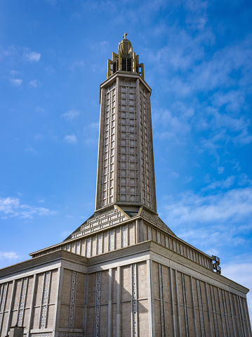 Saint Joseph's Church (Eglise St. Joseph) in downtown Le Havre City from below against blue summer sky. St. Joseph's Church in Le Havre is a Roman Catholic Church built between 1951 and 1957 as part of this reconstruction of Le Havre City, it acts as a memorial to the five thousand civilians fallen in World War II. The church tower is 107 meters tall and acts as a beacon visible from out at sea. Le Havre, Normandy, France, Europe.