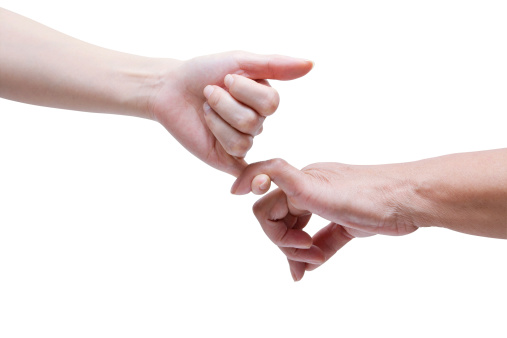 Senior and young crossing their little finger as symbol of promise isolated on white background. (Clipping Path!)