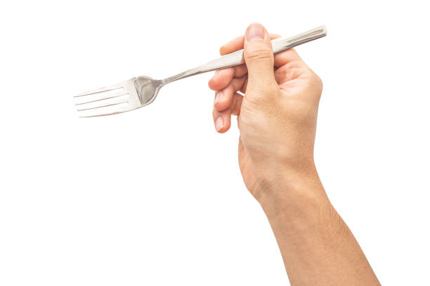 istock isolated of a man's hand holding a silver steel fork. 1658304182