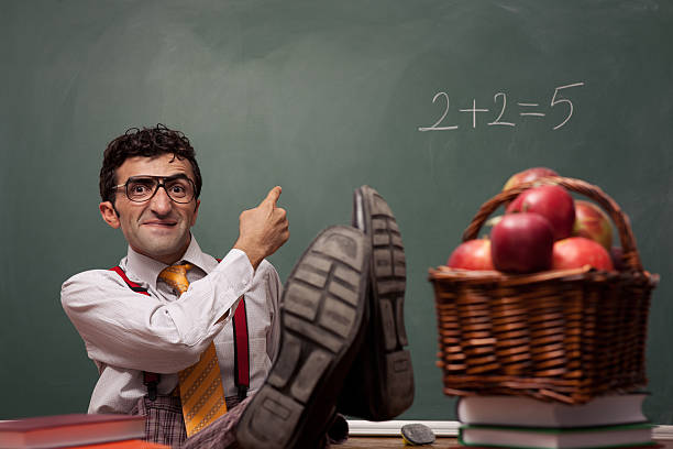 Nerd teacher in classroom with basket of apples Nerd teacher in classroom with basket of apples professor photos stock pictures, royalty-free photos & images