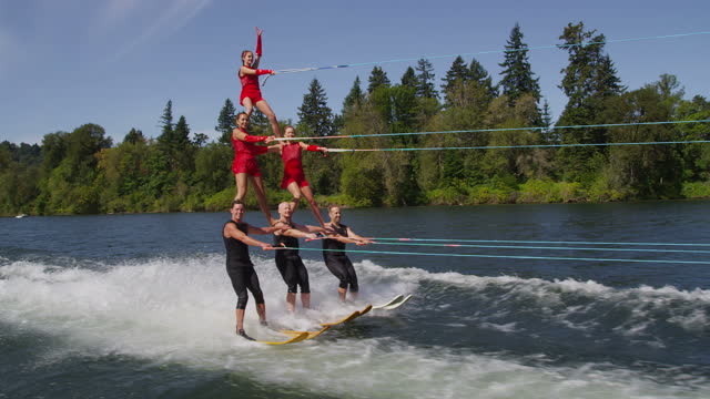 Stunt water skiers form human pyramid
