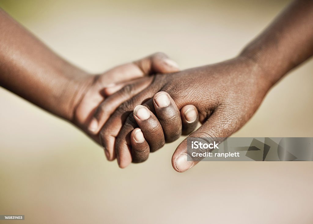 Two African Children Holding Hands Two young African children holding hands. Holding Hands Stock Photo