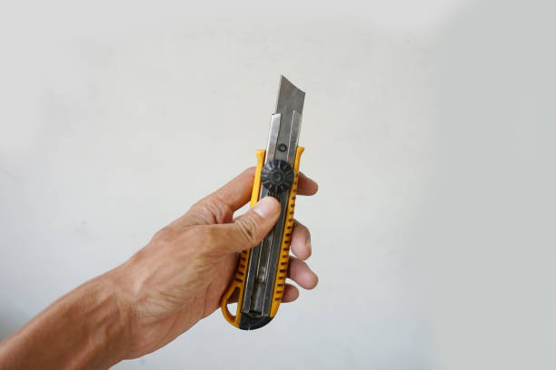 istock hand holding a cutter knife 1658351513