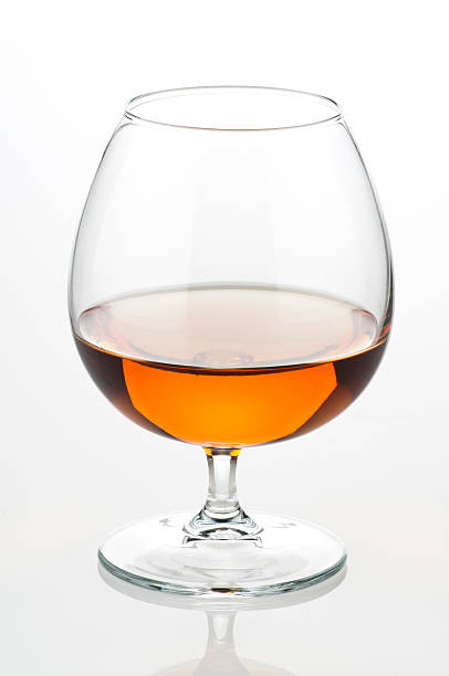 Close up view of a cognac glass or snifter half full Cognac Glass on White Backgroundhttp://i1215.photobucket.com/albums/cc503/carlosgawronski/CocktailsandDrinks.jpg cognac stock pictures, royalty-free photos & images