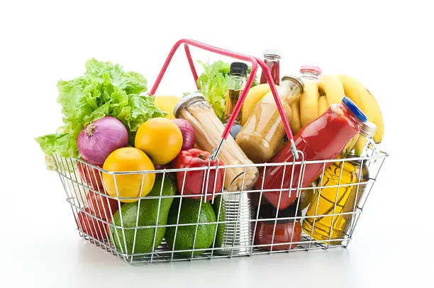 Photo of Wire shopping basket filled with groceries and vegetables