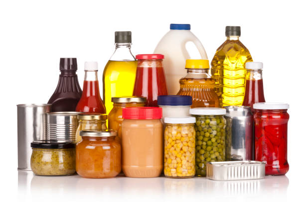 istock Large group of canned food sitting on white backdrop 165835419