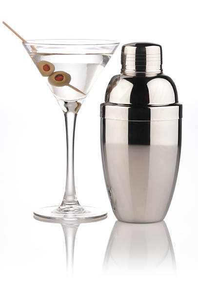 A martini and a metallic shaker Martini Glass and Shaker on Reflective White Background.  Similar Photos on Lightbox COCKTAIL AND DRINKShttp://i1215.photobucket.com/albums/cc503/carlosgawronski/CocktailsandDrinks.jpg cocktail shaker photos stock pictures, royalty-free photos & images