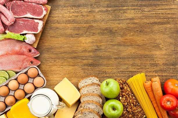 istock Food border on rustic wood table shot from above 165835506