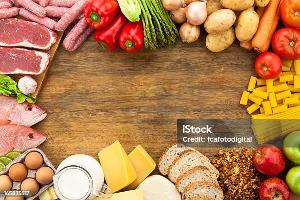 Border Of Different Types Of Food On Wooden Table Stock Photo - Download Image Now - Table, Groceries, Fish