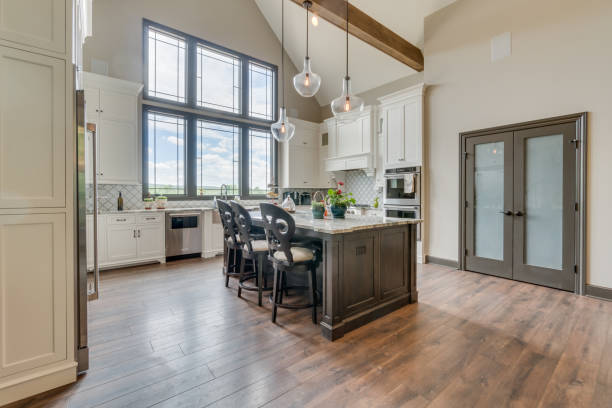 istock Spacious kitchen with pendant lights hanging over the kitchen island 1658376481