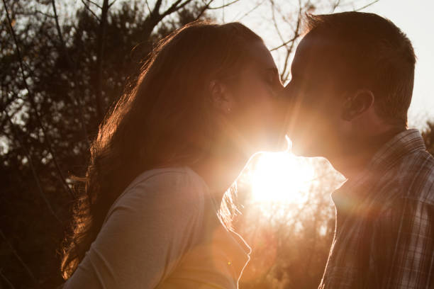 Kissing At Sunset In The Park stock photo