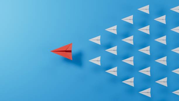 istock Leaderplane concept minimal with red paper plane leading among paper plane white.3D rendering on blue background. 1658390579