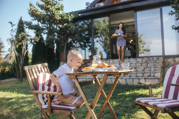 istock mother is preparing breakfast in the kitchen while her son is using a mobile phone 1658403858