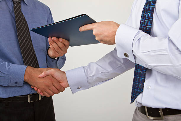 istock Two businessmen shaking hands on a deal 165840654