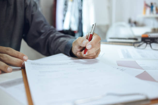 istock businessma review documents before sign 1658407469
