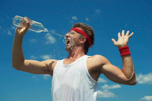 Nerd athlete tries to take a drink of water but misses and sprays himself in the face