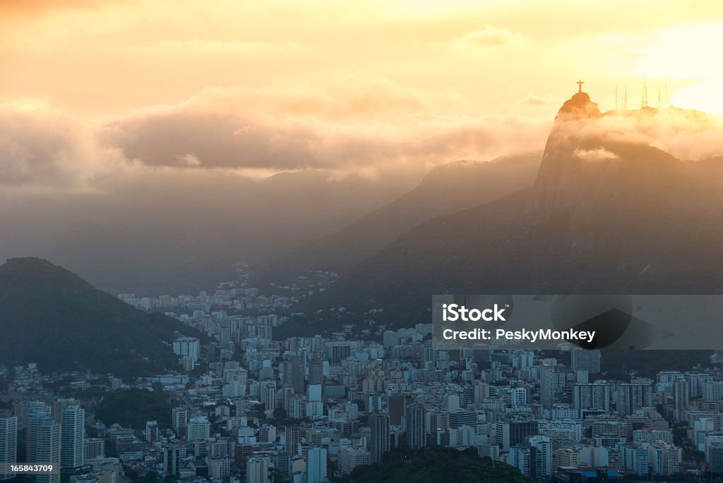 Rio de Janeiro Brazil Golden Sunset Skyline Golden sun glows as it sets into the mist above Rio de Janeiro Brazil Brazil Stock Photo
