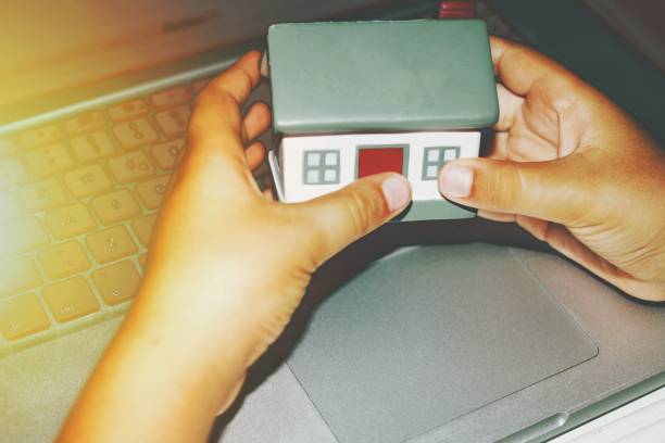 istock House model hold in two hands . Conceptual photo. 1658440294
