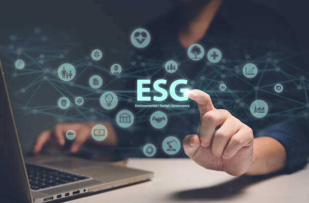 istock Man touching ESG hologram, a concept of sustainable development that combines environment, society, and governance. The hologram consists of icons of trees, robots, bank, heart, family, factory, air, money, data, and network. 1658479772