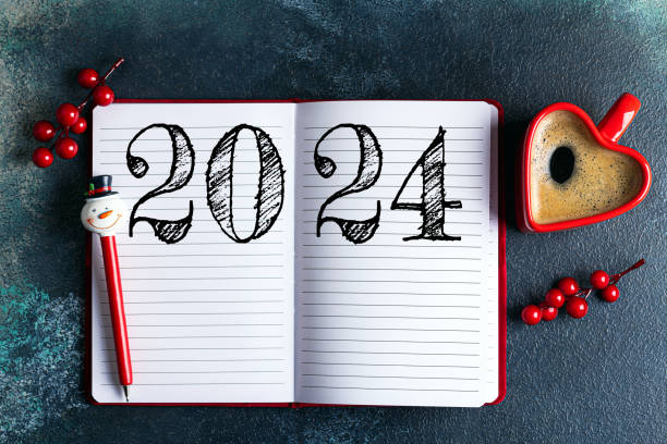 istock New year resolutions 2024 on desk. 2024 goals list with notebook, coffee cup on blue table. Resolutions, plan, goals, action, checklist, idea concept. New Year 2024 resolutions 1658519541