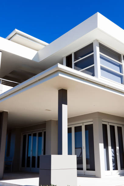 istock Modern white house in sunlight against blue sky, copy space 165852875