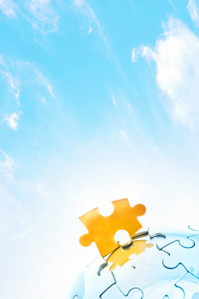 istock Golden jigsaw piece against bright sky 165853167