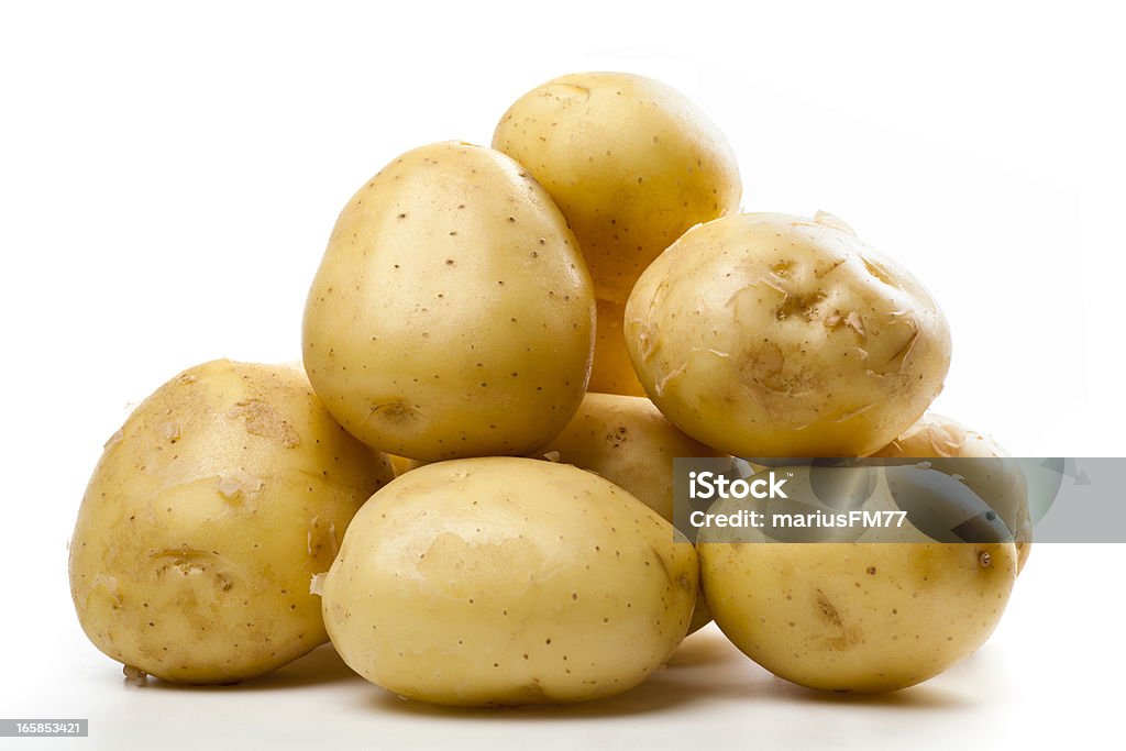 A pile of small yellow potatoes isolated potatoes over white background Raw Potato Stock Photo
