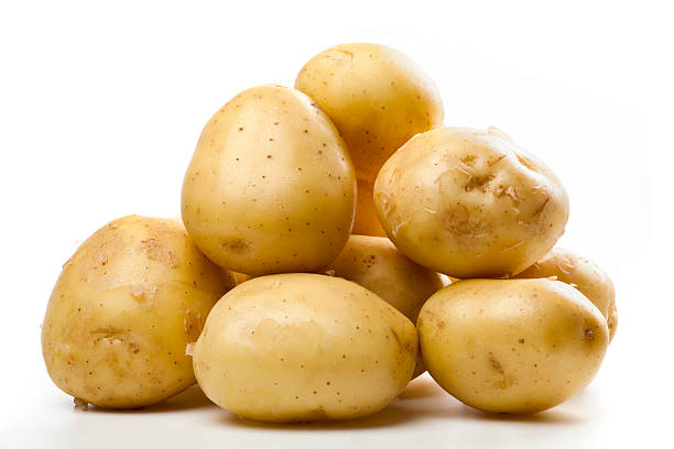 A pile of small yellow potatoes stock photo
