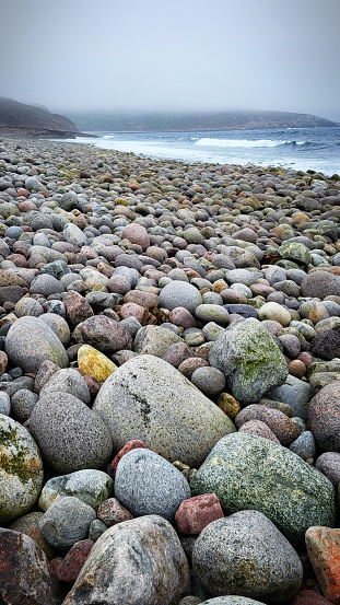 a lot of huge stones on the beach near the North sea. Dragon eggs beach. The edge of the earth