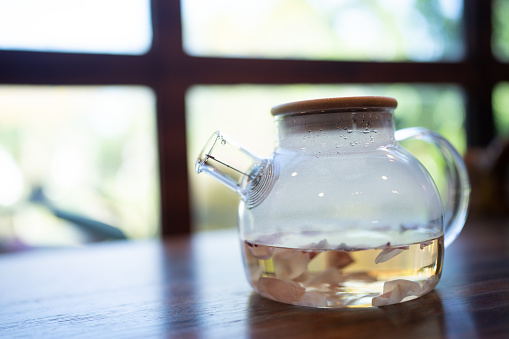 Blooming, Flowering Tea in Glass Teapot, Glass teapot with flowering tea for drinking in the morning or afternoon relaxing time of the day