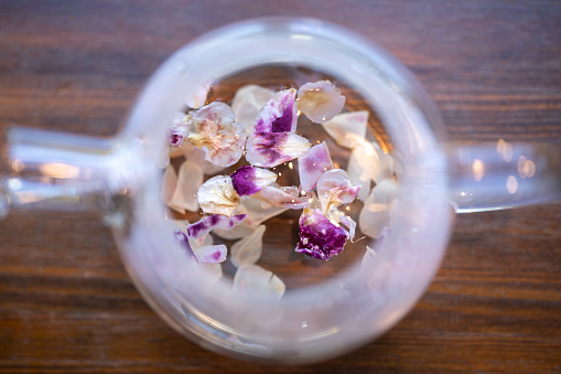 Blooming, Flowering Tea in Glass Teapot, Glass teapot with flowering tea for drinking in the morning or afternoon relaxing time of the day