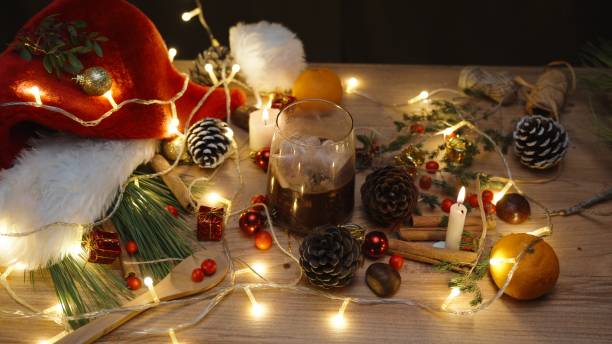 istock Christmas table with candles and decorations. Mug with hot chocolate and marshmallows 1658570315