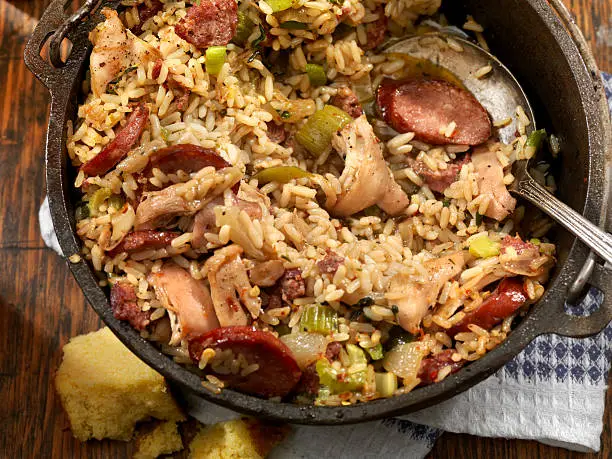 Cajun Style Chicken and Sausage Jambalaya in a Cast Iron Pot with Hot sauce and corn bread- Photographed on Hasselblad H3D2-39mb Camera