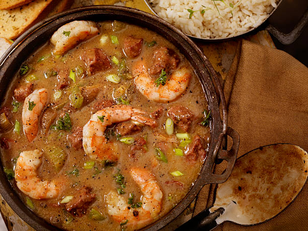 Shrimp and Sausage Gumbo Creole Style Shrimp and Sausage Gumbo in a cast iron pot with White Rice and French Bread- Photographed on Hasselblad H3D2-39mb Camera cajun food photos stock pictures, royalty-free photos & images