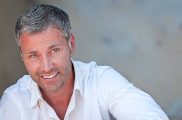 istock smiling man with grey hair 165857476